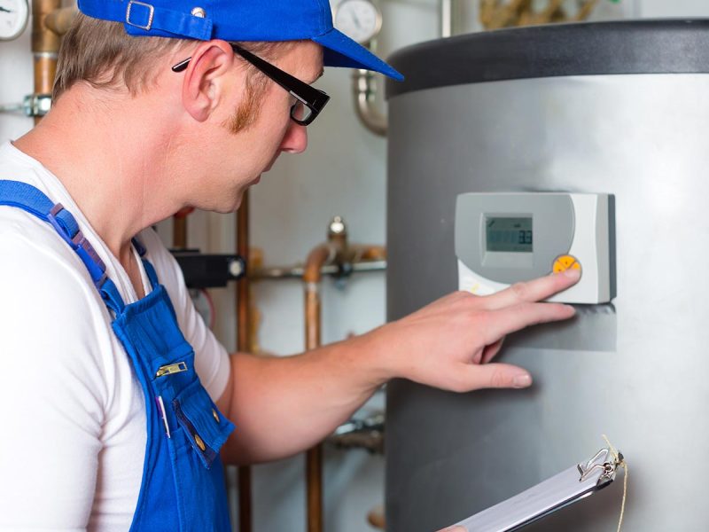 Engineer controlling the heating pipes at the boiler room